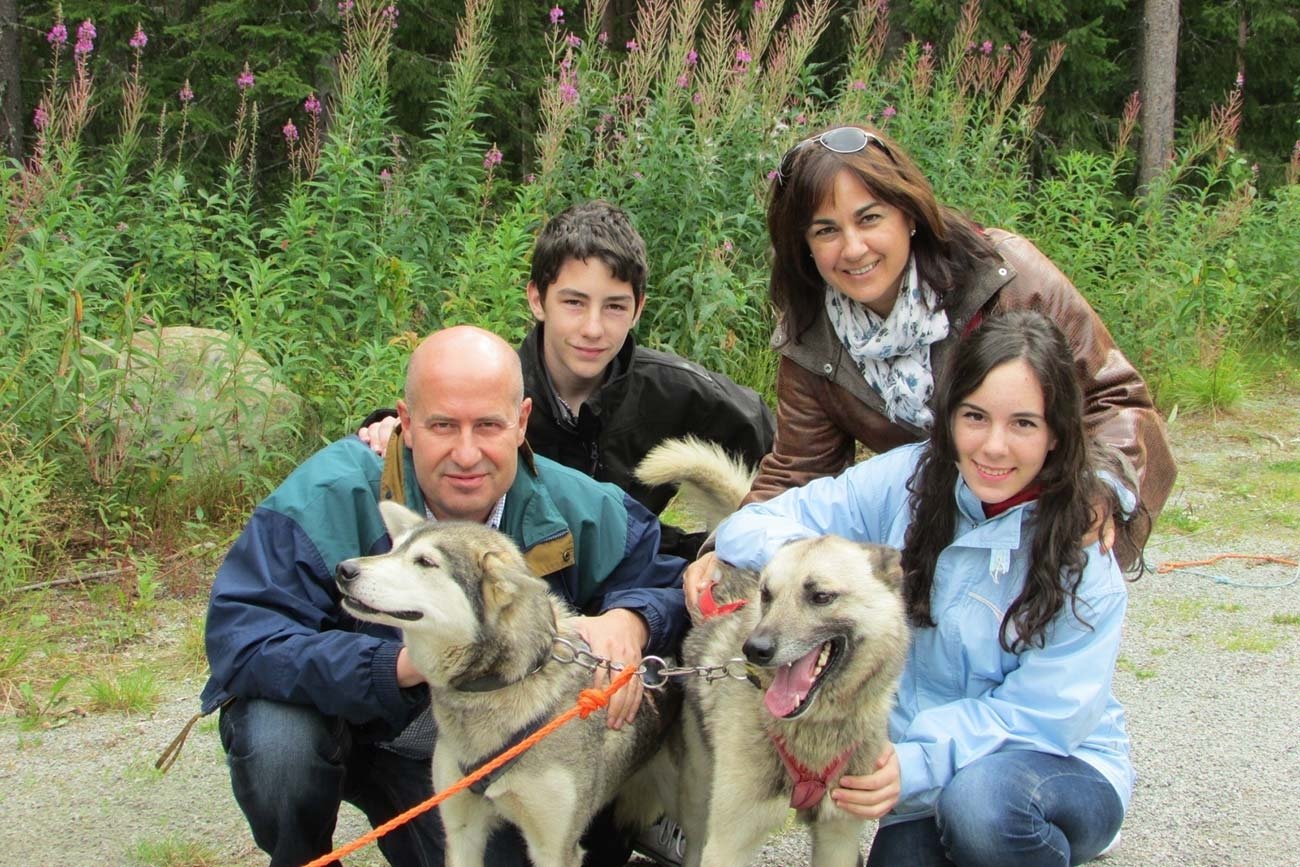 Family dog sledding on wheels. Beito Husky Tours